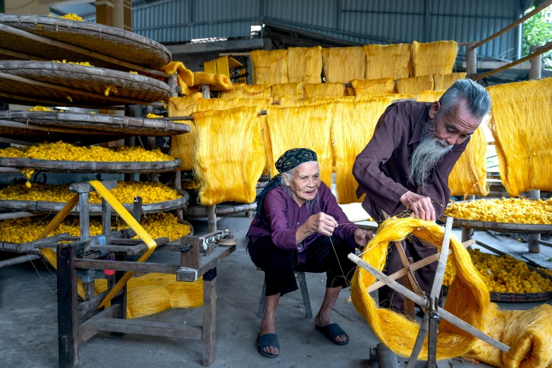 a man and a woman working in a factory, inspired by Nam Gye-u, pexels contest winner, process art, yellow parasol, two old people, made of wool, churning