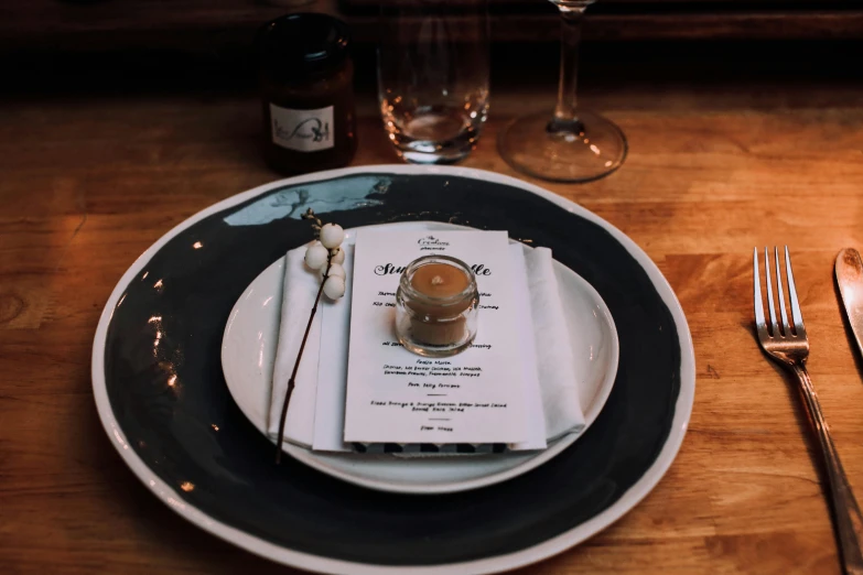 a close up of a plate on a table, unsplash, private press, charcoal and champagne, soup, cold brew coffee ), place setting