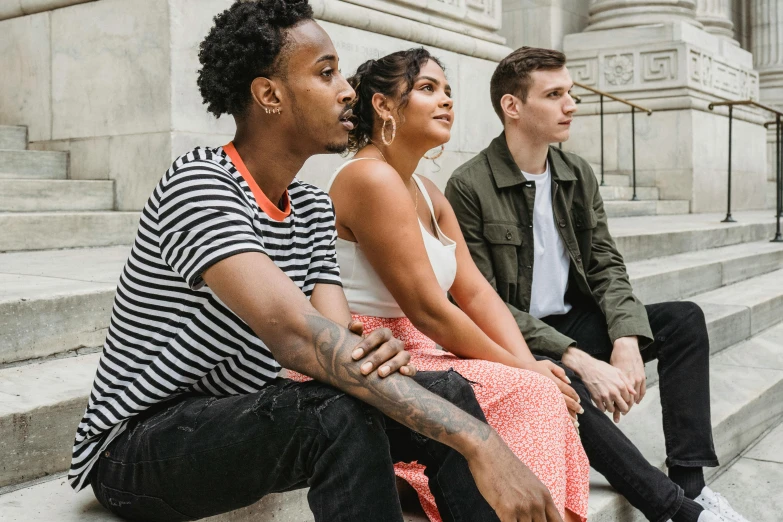 three people sitting on the steps of a building, an album cover, pexels contest winner, looking to the side off camera, mixed race, liberty statue sitdown pose, profile image