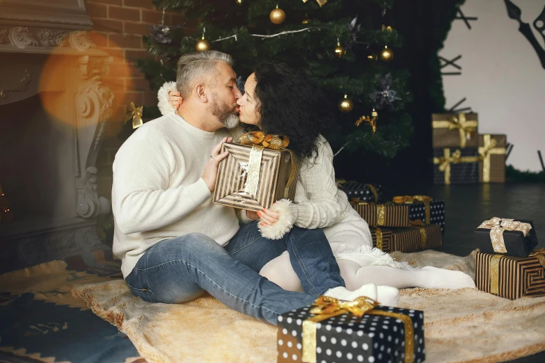 a man and woman sitting in front of a christmas tree, pexels contest winner, renaissance, couple kissing, cardboard, grey, 15081959 21121991 01012000 4k