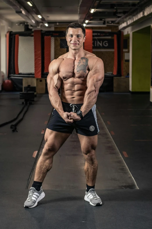 a man posing for a picture in a gym, damian kryzwonos, professionally taken, frontal pose, lee griggs