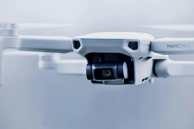 a white drone with a camera attached to it, unsplash, eyes projected onto visor, close - up studio photo, cctv camera footage, thumbnail