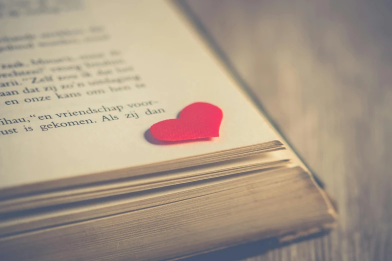 a red heart sitting on top of an open book, pexels contest winner, instagram post, dusty library, 15081959 21121991 01012000 4k, friendship