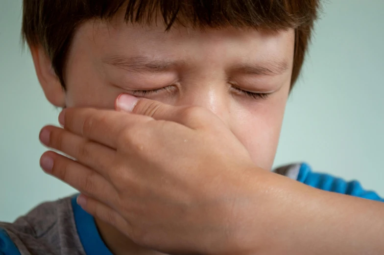 a young boy covers his eyes with his hands, by Eglon van der Neer, shutterstock, drinking cough syrup, closeup photograph, 15081959 21121991 01012000 4k, 4 0 0 0 0 0