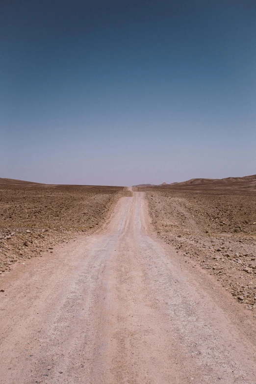 a dirt road in the middle of a desert, by Jacob Toorenvliet, les nabis, reza afshar, taken in the early 2020s, afar, wide roads