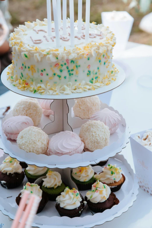 a three tiered cake sitting on top of a table, afternoon