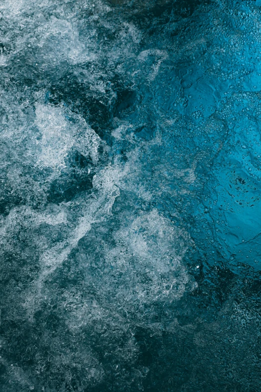 a man riding a surfboard on top of a wave, an album cover, inspired by Elsa Bleda, trending on unsplash, lyrical abstraction, underwater crystals, prussian blue, texture detail, lots of bubbles