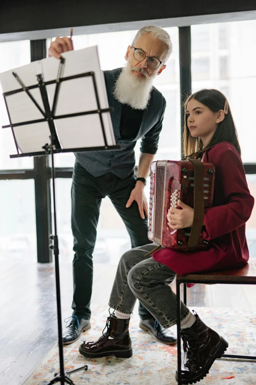 a man playing an accordion next to a little girl, inspired by Hendrick Avercamp, pexels contest winner, renaissance, overalls and a white beard, mc escher and ronny khalil, in a classroom, santa