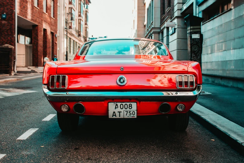 a red car parked on the side of a street, pexels contest winner, mustang, 🦩🪐🐞👩🏻🦳, retro style ”, back turned