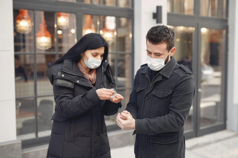 a man and a woman looking at their cell phones, by Adam Marczyński, happening, medical mask, square, 268435456k film, hand