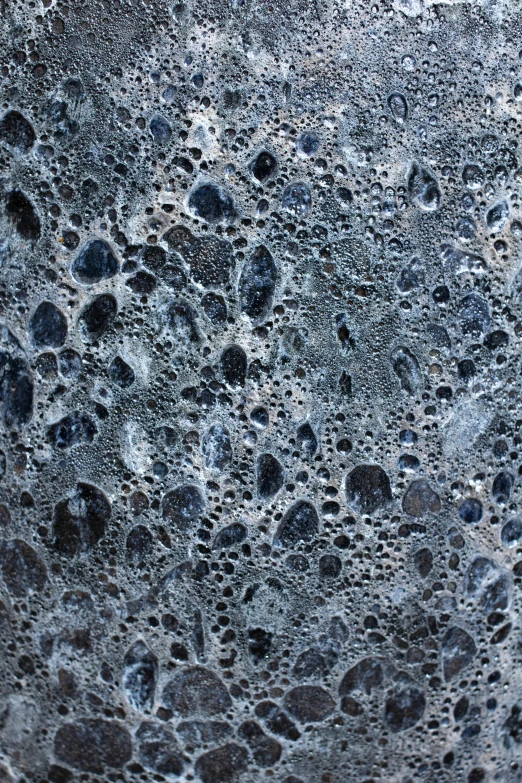 a close up of the surface of a rock, a microscopic photo, inspired by Vija Celmins, unsplash, concrete art, ocean pattern and night sky, made of liquid metal and marble, 2010s, made of lava