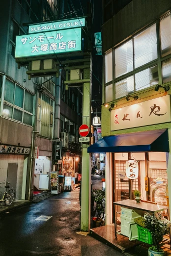 a street in an asian city at night, a picture, unsplash, ukiyo-e, green neon signs, small buildings, けもの, instagram story