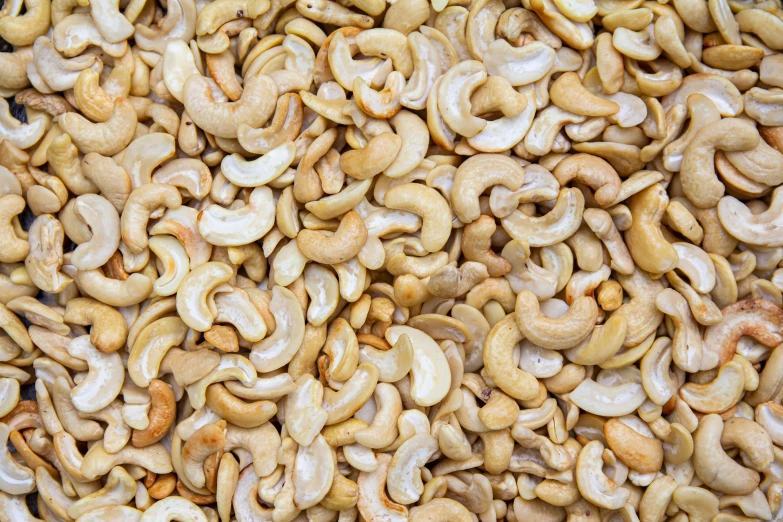 a pile of cashews sitting on top of a table, shutterstock, 3 2 x 3 2, background image, swirl, upscaled to high resolution