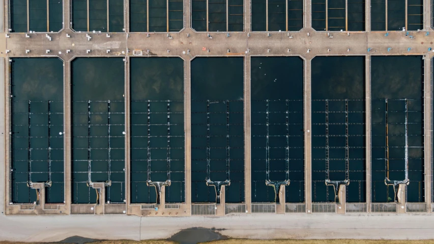 a red fire hydrant sitting in front of a tall building, a portrait, unsplash, dutch angle from space view, rows of doors, docks, turbines