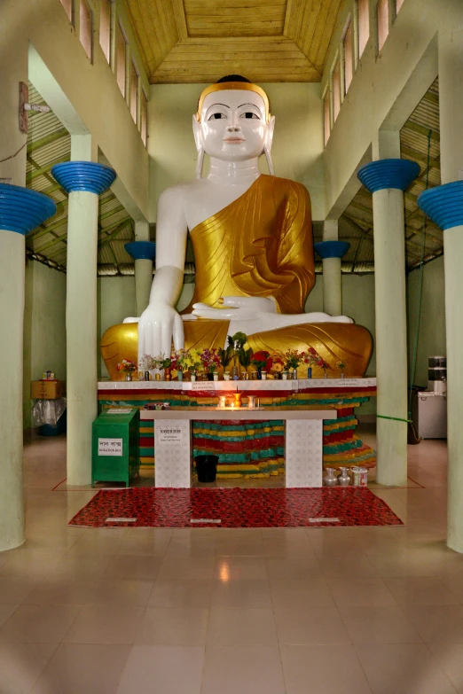 a large buddha statue sitting inside of a building, divayth fyr, touring, square, february)