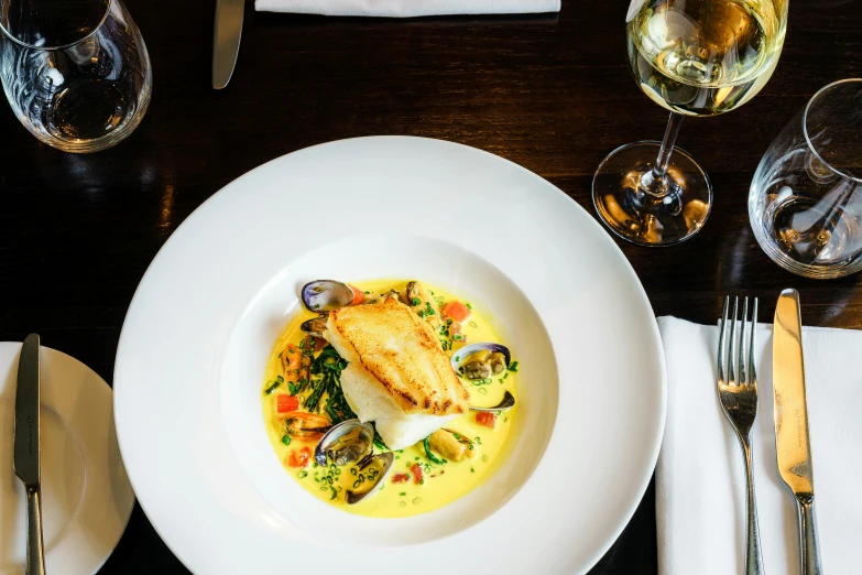 a close up of a plate of food on a table, inspired by Richmond Barthé, pexels contest winner, renaissance, bolts of bright yellow fish, wellington, looking across the shoulder, abalone