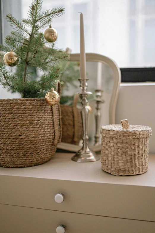 a small christmas tree sitting on top of a window sill, by Nina Hamnett, unsplash, baroque, wicker art, covered chest, beige, product shot