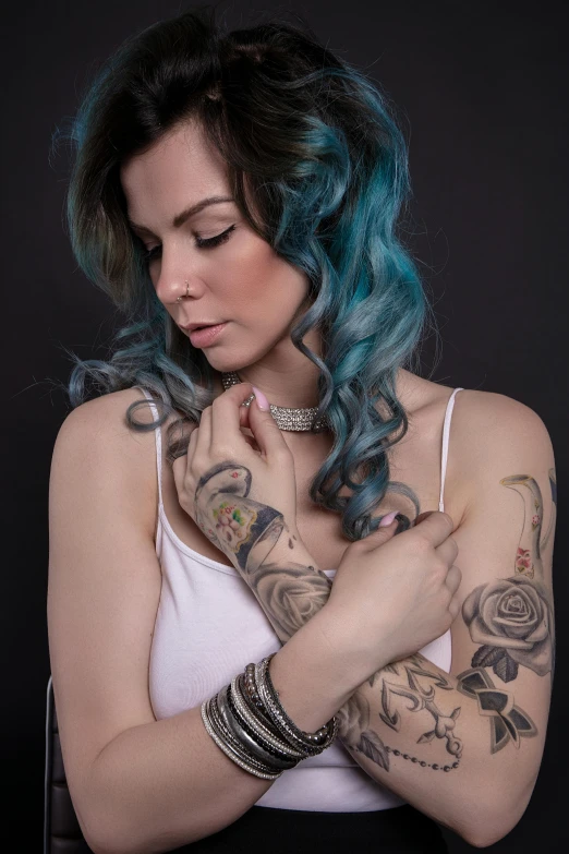 a woman with blue hair and tattoos on her arms, inspired by Elsa Bleda, better known as amouranth, profile image, curls, rose tattoo