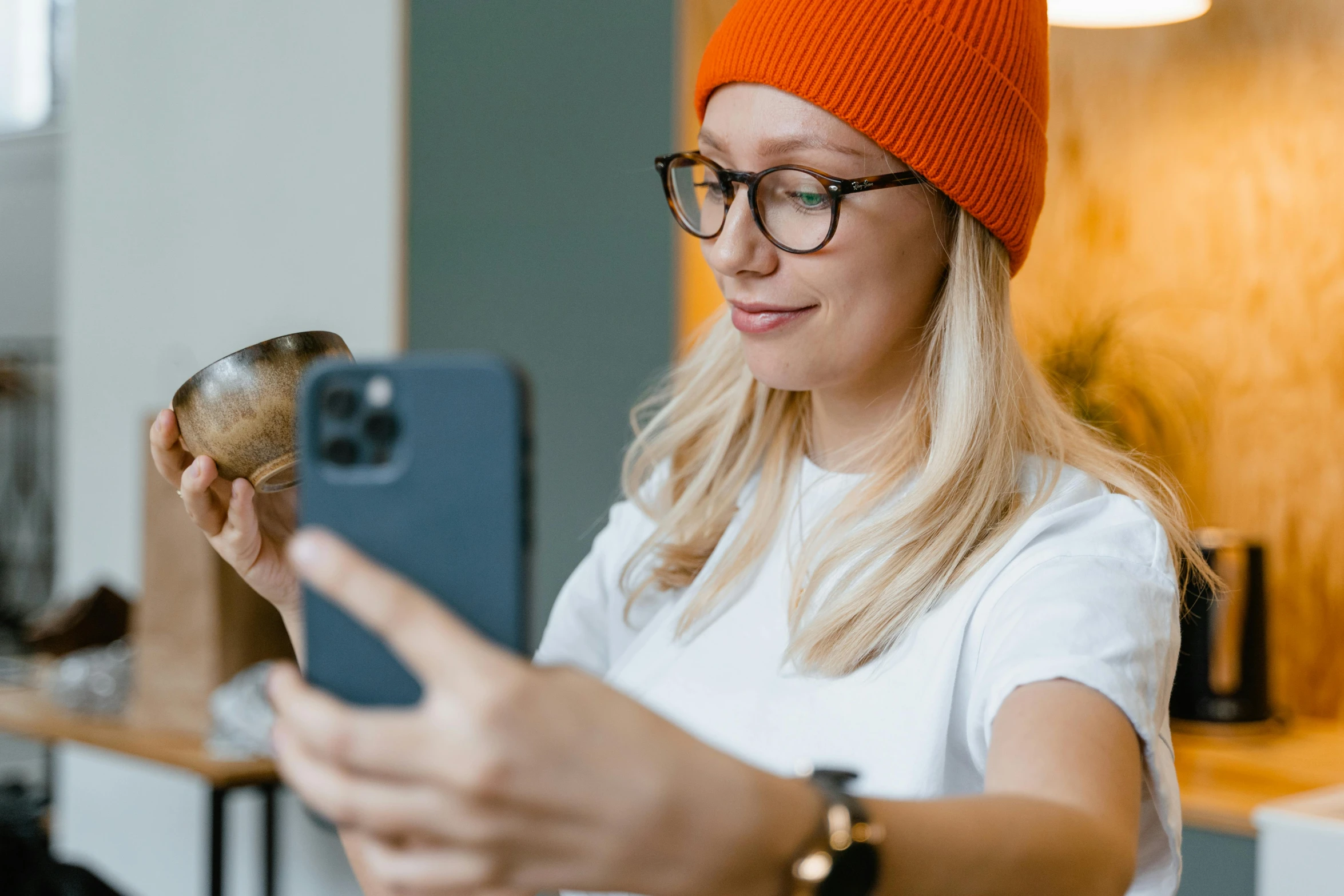 a woman taking a selfie with her cell phone, trending on pexels, pixel art, beanie, square rimmed glasses, orange hue, a blond