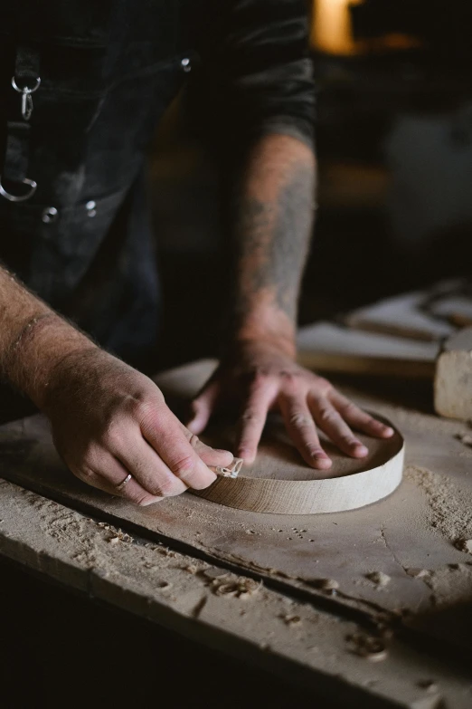 a close up of a person making a piece of wood, by Jessie Algie, round format, manly design, 2 1 0 mm, low