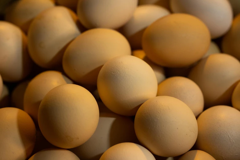 a pile of eggs sitting on top of a table, light tan, thumbnail, low detail