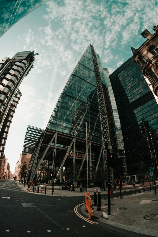 a city street filled with lots of tall buildings, a picture, by IAN SPRIGGS, unsplash contest winner, huge glass structure, low angle fisheye view, panoramic, three towers