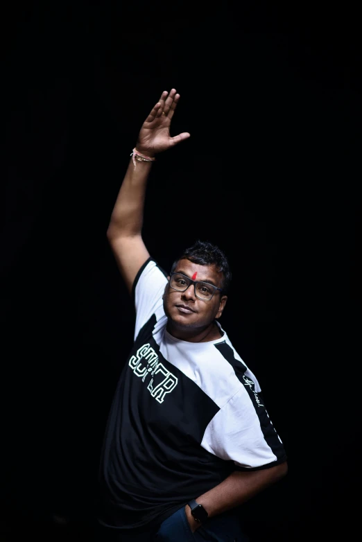 a man holding a tennis racquet on top of a tennis court, by Rajesh Soni, rapping on stage at festival, on black background, saluting, half man half asian black bull