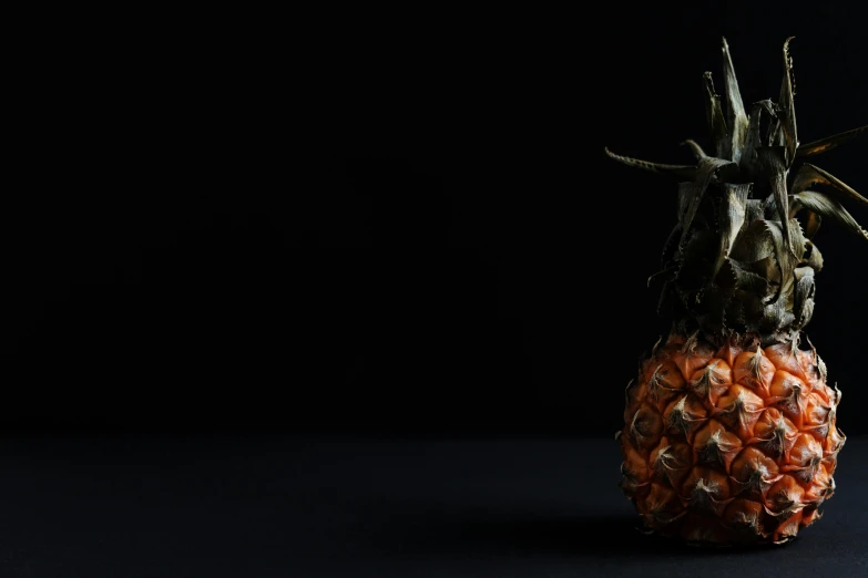 a close up of a pineapple on a black background, an album cover, by Adam Marczyński, unsplash contest winner, eating rotting fruit, iron throne from game of thrones, black and orange, minimalist background