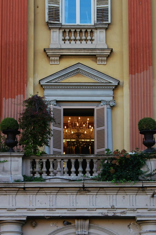 a clock that is on the side of a building, inspired by Vincenzo Cabianca, neoclassicism, at the terrace, ocher details, evening, black and terracotta