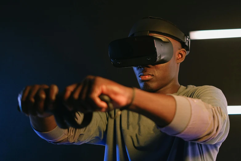a man using a virtual reality device in a dark room, farsight xr-20, afro tech, thumbnail, in an action pose