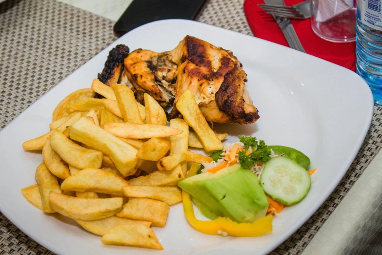 a close up of a plate of food on a table, grilled chicken, obunga, french fries as arms, image