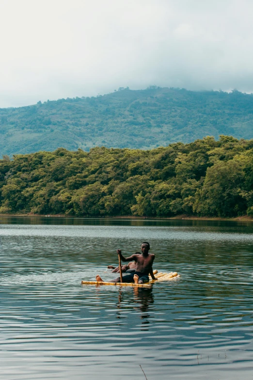 a man riding a paddle board on top of a lake, by Jessie Algie, hurufiyya, adut akech, slide show, mongezi ncaphayi, 2 people