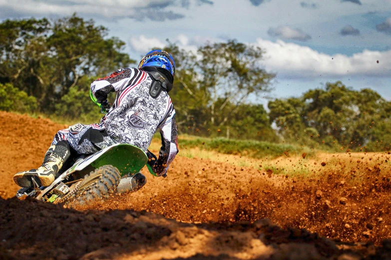 a person riding a dirt bike on a dirt track, by Felipe Seade, avatar image, getty images, sao paulo, a green