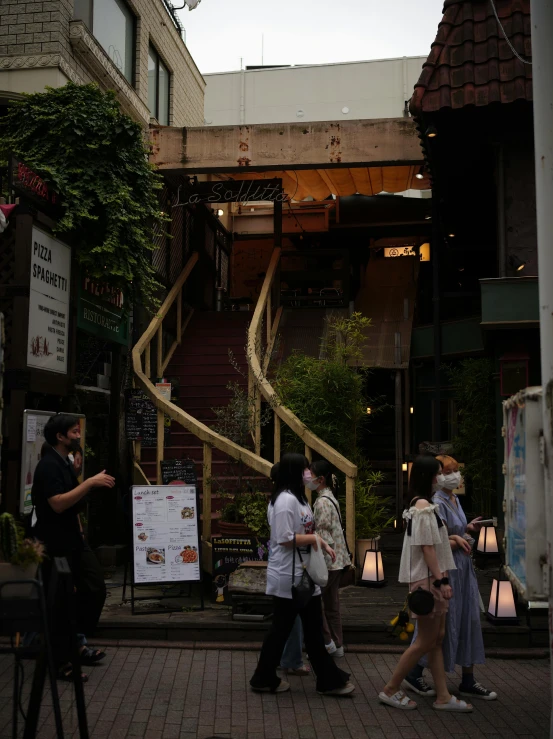 a group of people walking down a sidewalk, stairs to an upper floor, tokyo izakaya scene, slide show, 2 0 2 2 photo