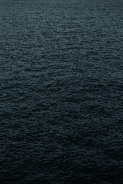 a boat floating on top of a large body of water, an album cover, by Vija Celmins, unsplash, minimalism, 2 5 6 x 2 5 6 pixels, dark wallpaper, ocean pattern, ignant