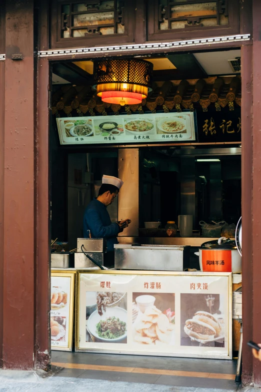 a man standing in the doorway of a restaurant, a silk screen, trending on unsplash, crispy buns, wok, square, high quality photo