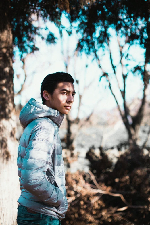a man standing next to a tree in a forest, inspired by Li Keran, unsplash, shin hanga, model wears a puffer jacket, headshot profile picture, profile image, hiking clothes