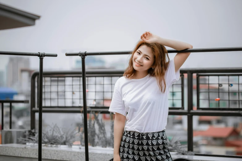 a beautiful young woman standing on top of a building, inspired by Kim Jeong-hui, trending on pexels, happening, white tshirt, young cute wan asian face, outfit photo, malaysian