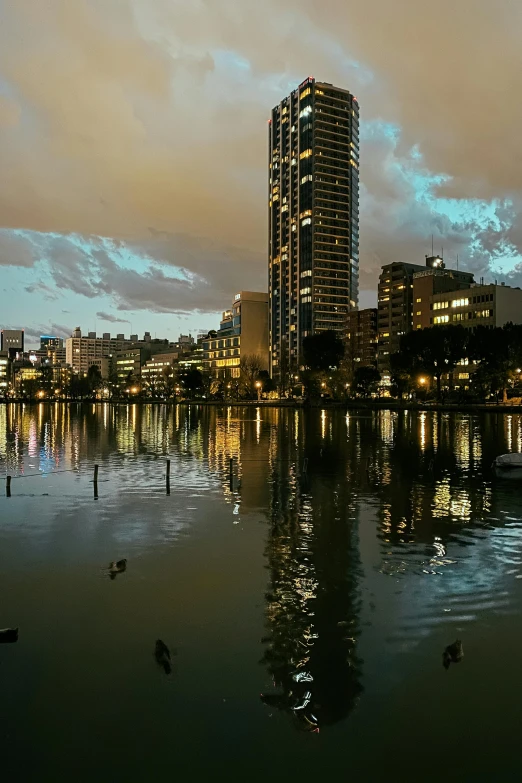 a large body of water surrounded by tall buildings, serene evening atmosphere, gold coast australia, seville, ominous evening