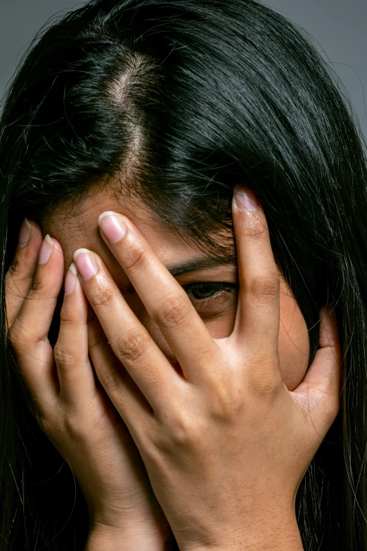 a woman covering her face with her hands, a picture, shutterstock, hurufiyya, portrait of depressed teen, exotic expression, taken in the late 2010s, instagram post
