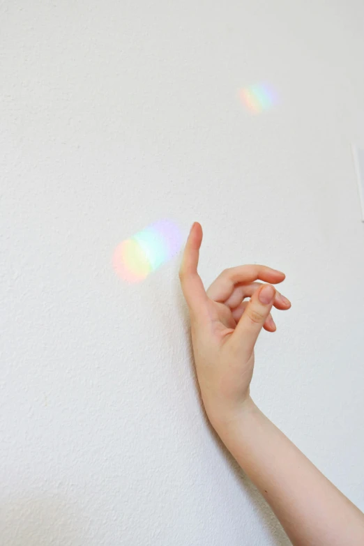 a close up of a person holding a toothbrush, inspired by Gabriel Dawe, holography, hanging out with orbs, on a white background, light coming from the windows, tiny rainbow triangles