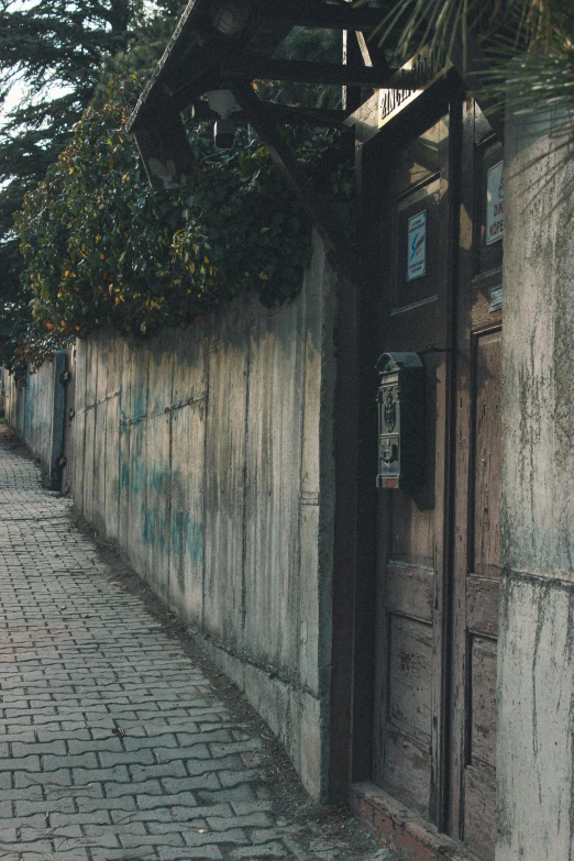 a red fire hydrant sitting on the side of a road, an album cover, inspired by Elsa Bleda, unsplash contest winner, graffiti, wooden houses, istanbul, small path up to door, 1996)