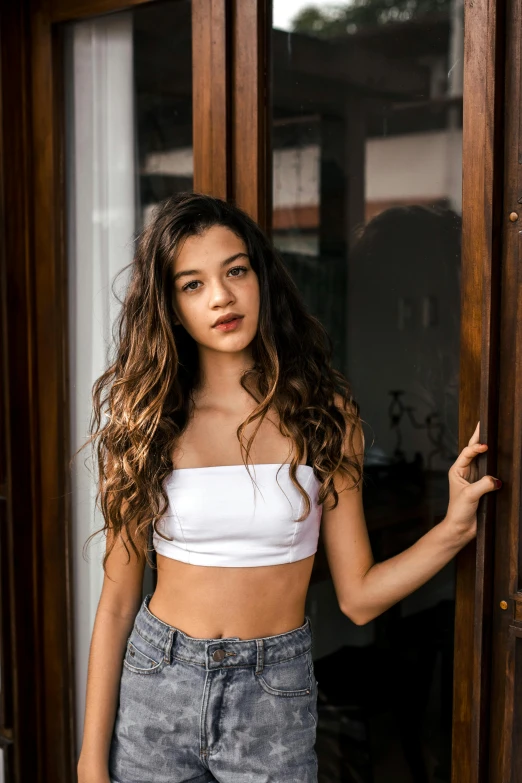 a beautiful young woman standing in front of a door, trending on pexels, renaissance, croptop, asher duran, mid long hair, 🤤 girl portrait