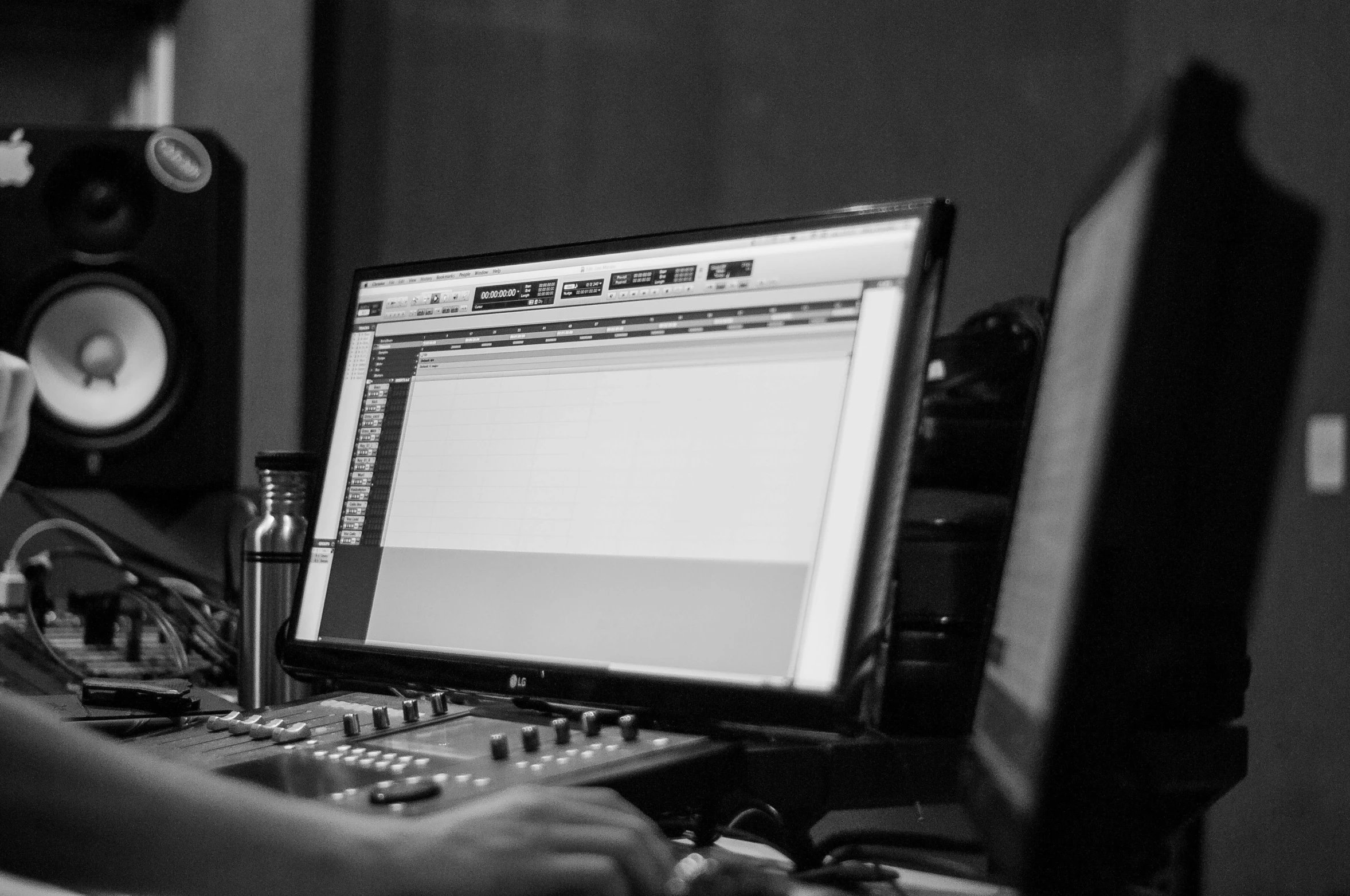 a man that is sitting in front of a computer, a black and white photo, by Dennis Flanders, unsplash, process art, music being played, close - up studio photo, production ig studios, charts