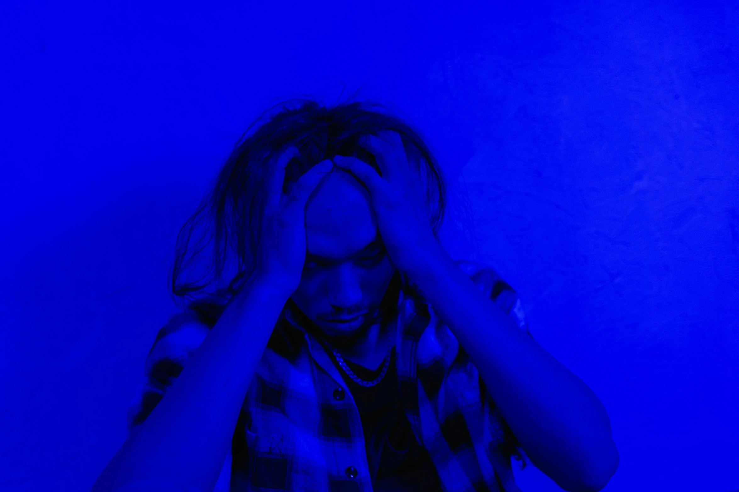 a man holding his head in his hands, pexels, digital art, electric blue, teenage girl, trippie redd, portrait of depressed teen