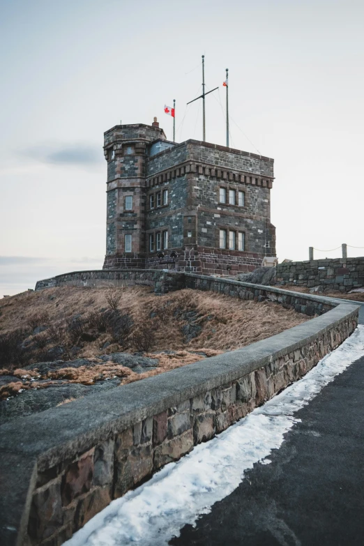 a large stone building sitting on top of a hill, pexels contest winner, quebec, watch tower, victoria, exterior photo