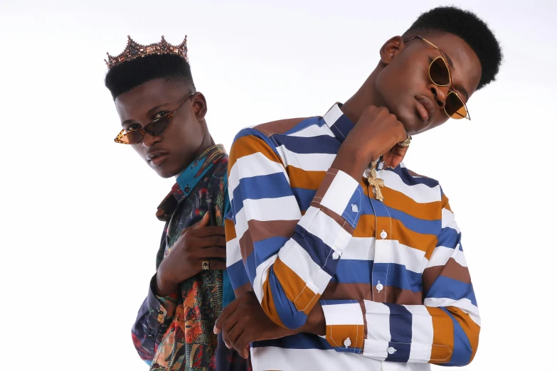a couple of men standing next to each other, an album cover, by Ingrida Kadaka, trending on pexels, afrofuturism, wearing kings crown, cute boys, high fashion modeling, flat top haircut