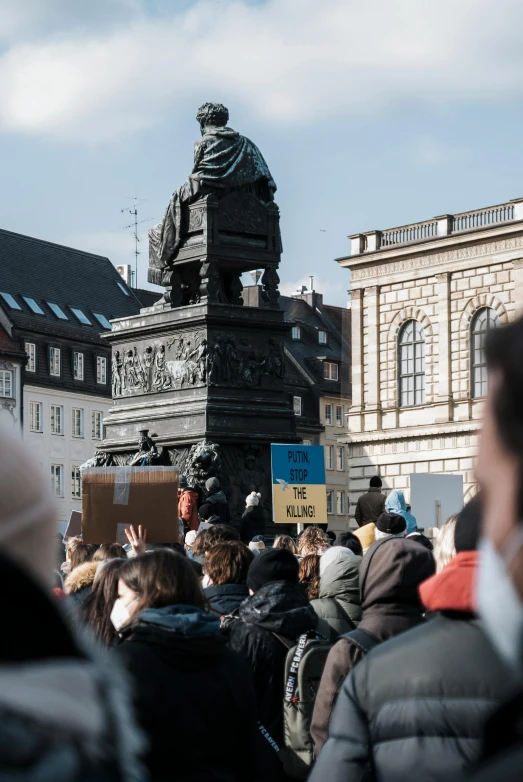 a crowd of people standing around a statue, a statue, by Sigrid Hjertén, unsplash, renaissance, protesters holding placards, square, german, 🚿🗝📝