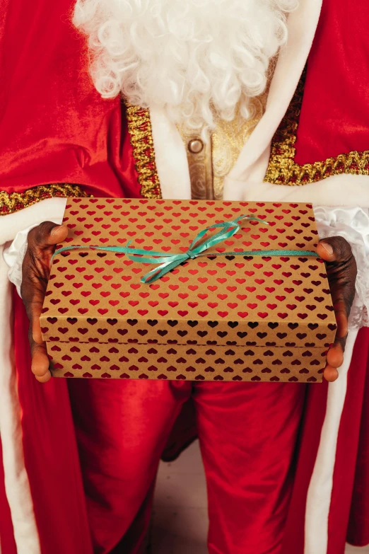 a man dressed as santa claus holding a present, an album cover, by Julia Pishtar, pexels, renaissance, royal robe, middle close up, inside its box, 7