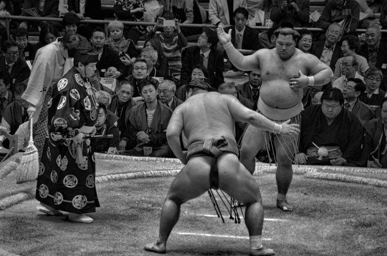 a black and white photo of two sumo wrestlers in a ring, a black and white photo, flickr, feudal japanese setting, square, monochrome hdr, bleeding audience